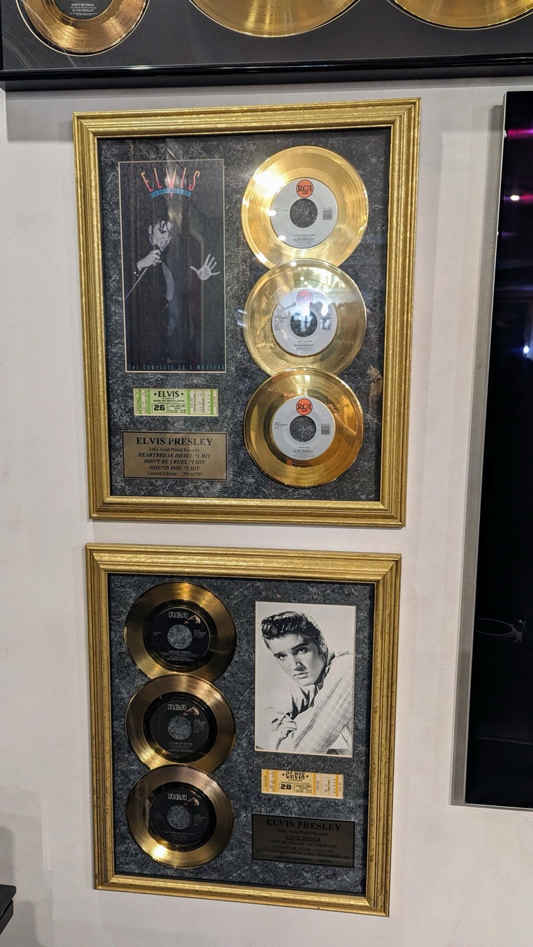 A framed records on a wall
Description automatically generated