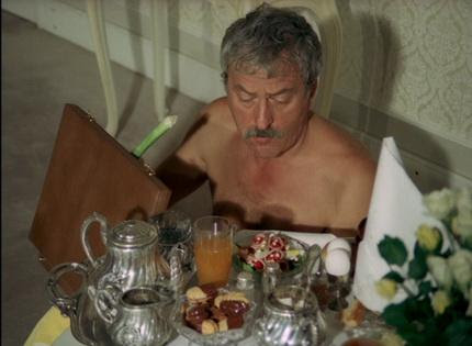 A person sitting at a table with food
Description automatically generated