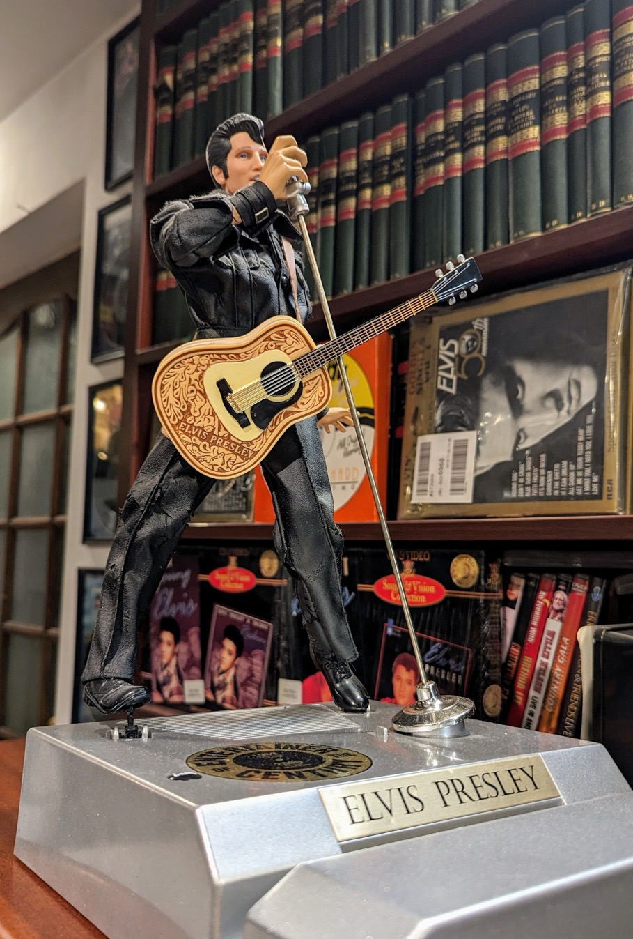 A statue of a person holding a guitar

Description automatically generated