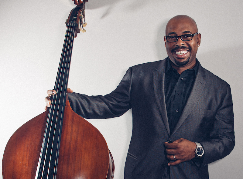 A person holding a bass
Description automatically generated