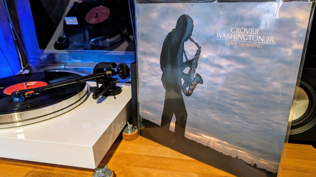 A record player and a cover of a person playing the saxophone

Description automatically generated