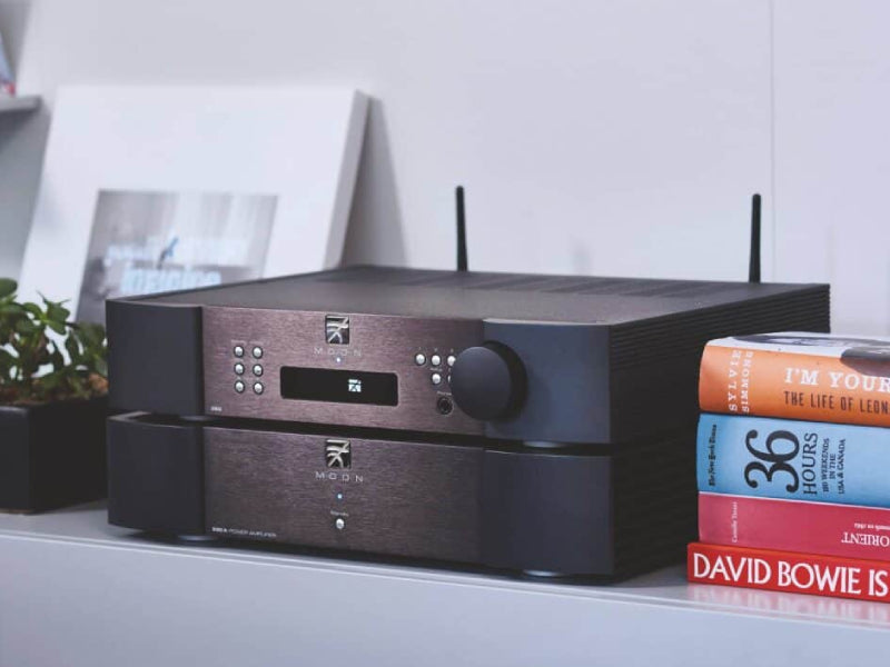 A black stereo system with a few books

Description automatically generated with medium confidence